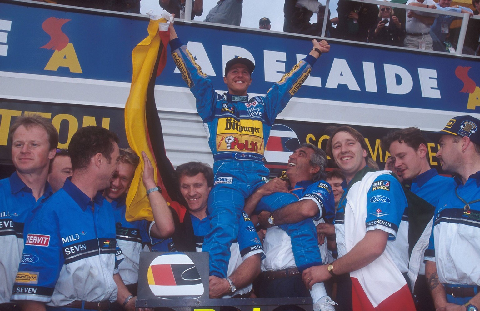 Australian Grand Prix 1994 - Adelaide - Michael Schumacher (GER, C) celebrates becoming World Champion with team principal Flavio Briatore (Italia, R) and Chief Engineer Tom Walkinshaw (Scotland, L) a ...