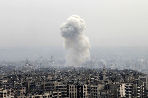 Smoke rises following a Syrian government air strike on rebel positions, in eastern Aleppo, Syria, Monday, Dec. 5, 2016. The government seized large swaths of the Aleppo enclave under rebel control si ...