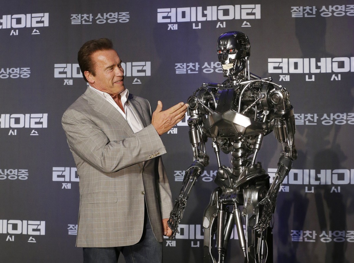 Actor Arnold Schwarzenegger stands with a model of a "Terminator" from the new film "Terminator Genisys" during a press conference at the Ritz Carlton hotel in Seoul, South Korea,  ...