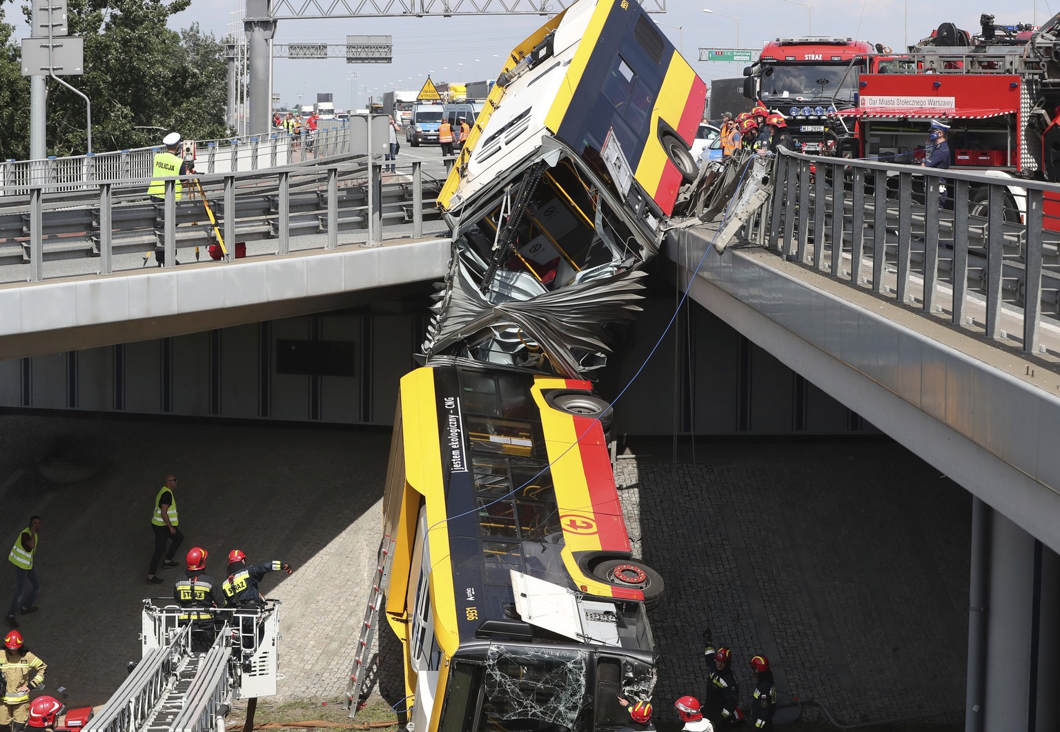 The wreckage of a Warsaw city bus is shown after the articulated bus crashed off an overpass, killing one person and injuring about 20 people, in Warsaw, Poland, on June 25, 2020. The accident forced  ...