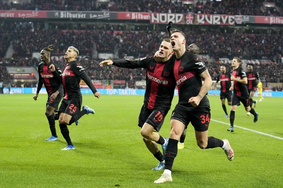 Leverkusen&#039;s Florian Wirtz, left, celebrates with team mate Leverkusen&#039;s Granit Xhaka, right, after scoring a goal that was seconds later disallowed by a VAR decision during the German Bunde ...