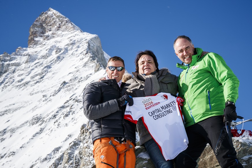 Pirmin Zurbriggen, former alpine ski racing champion from Switzerland, left, FC Sion President Christian Constantin, center, and Christophe Darbellay, State Councillor of Valais, right, pose with a T- ...