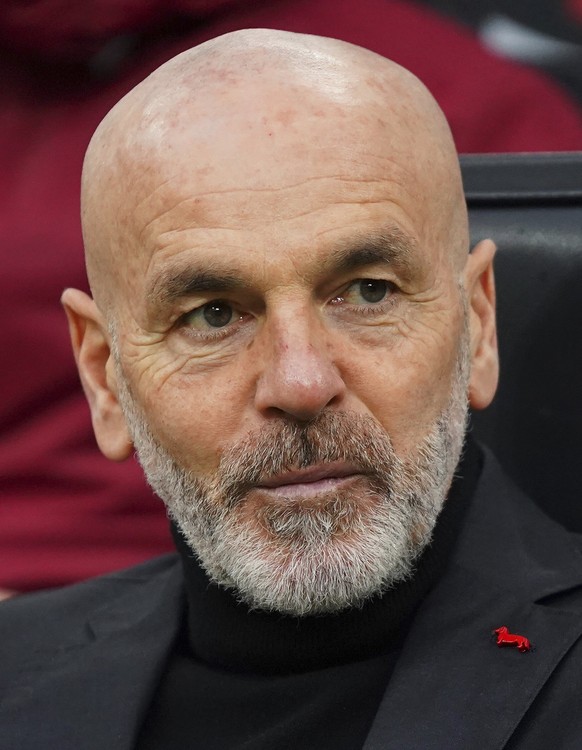 AC Milan coach Stefano Pioli sits on the bench prior to the Serie A soccer match between AC Milan and Crotone at the Milan San Siro Stadium, Italy, Sunday, Feb. 7, 2021. (Spada/LaPresse via AP)