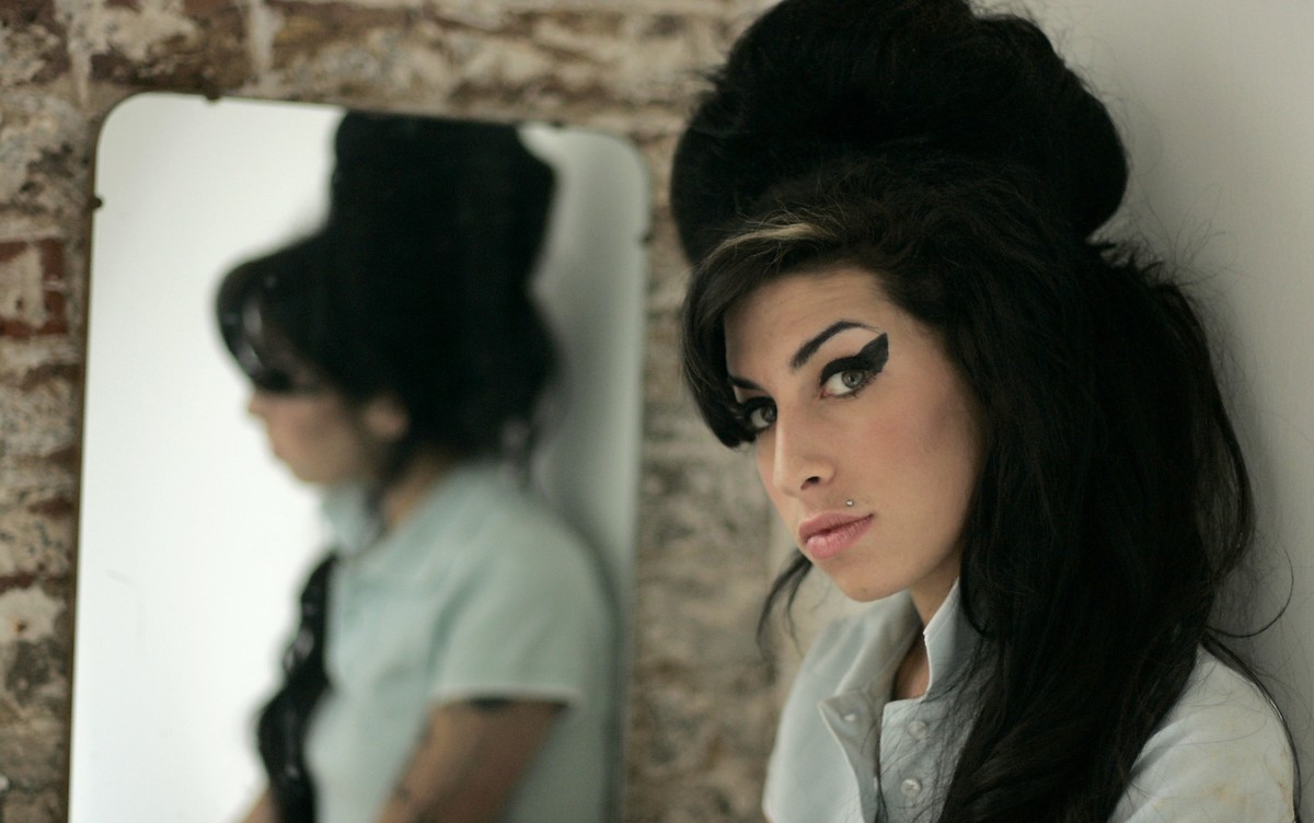 FILE - In this Feb. 16, 2007 file photo, British singer Amy Winehouse poses for photographs after being interviewed by The Associated Press at a studio in north London. Friday, July 23, 2021 marks the ...