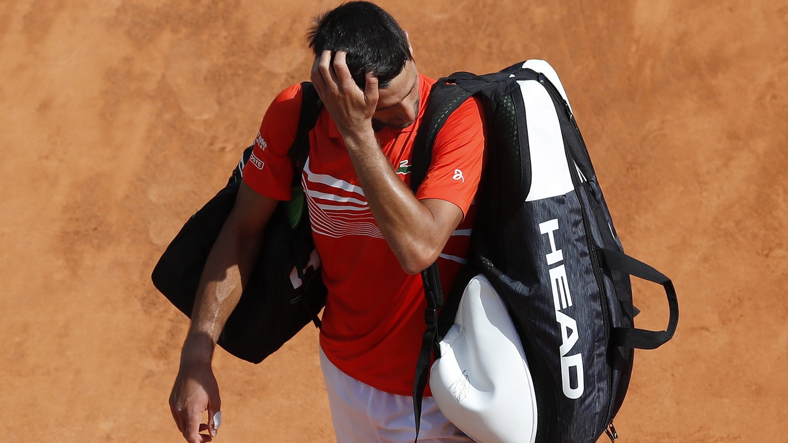 epa07515836 Novak Djokovic of Serbia leaves the court after losing his quarterfinal match against Daniil Medvedev of Russia at the Monte-Carlo Rolex Masters tournament in Roquebrune Cap Martin, France ...