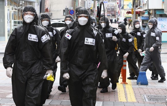 South Korean army soldiers wearing protective suits move to spray disinfectant in Daegu, South Korea, Sunday, March 15, 2020. For most people, the new coronavirus causes only mild or moderate symptoms ...