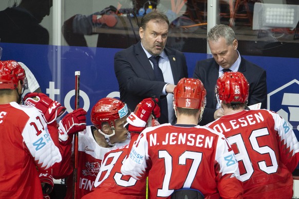 epa09224117 Heinz Ehlers, head coach of Denmark national ice hockey team, left, talks to his players, during the IIHF 2021 World Championship Group A match between Denmark and Switzerland at the Olymp ...