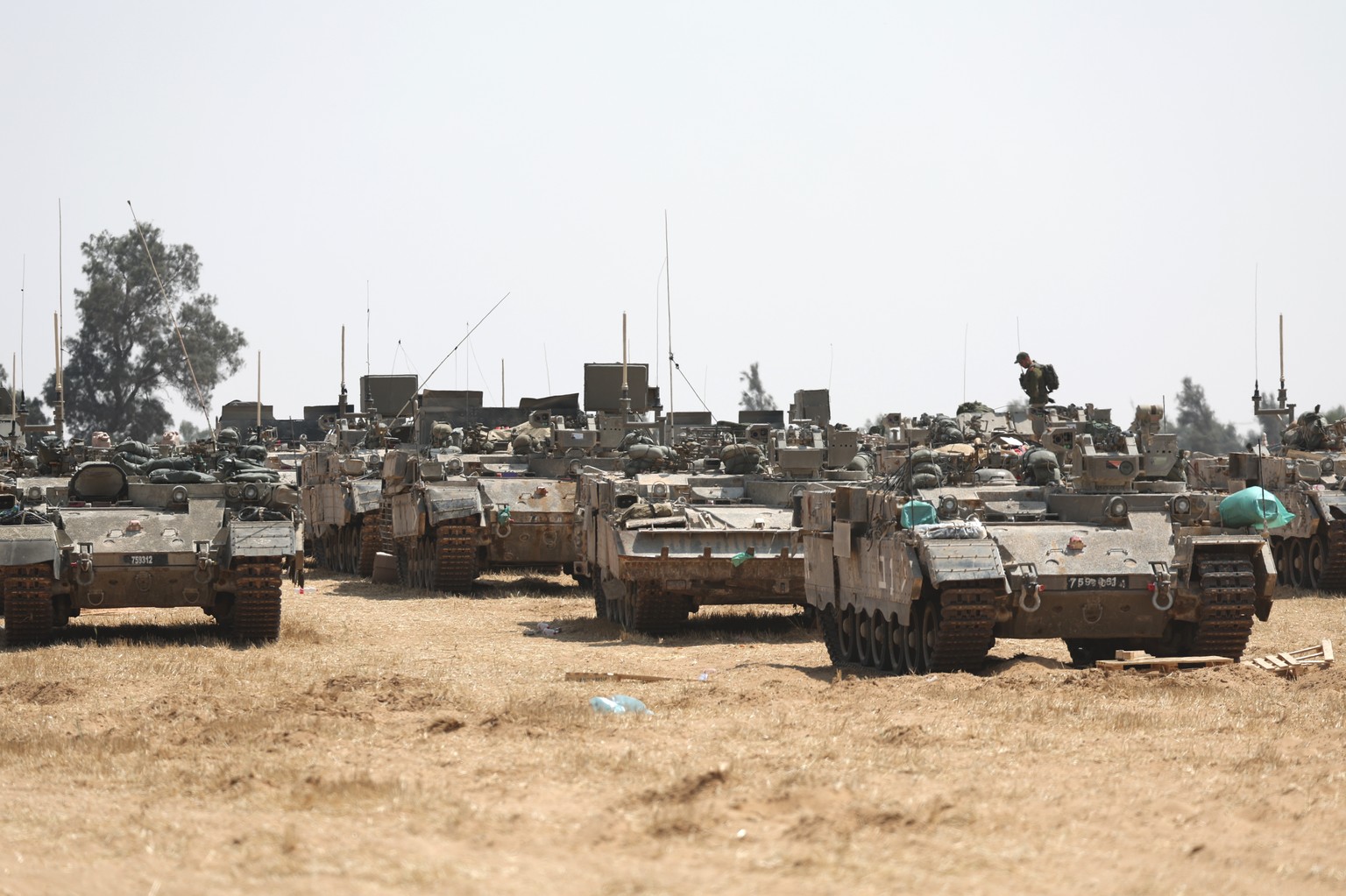 epa11312274 Israeli soldiers with military vehicles gather at a position on the southern Israeli border with the Gaza Strip, near the Palestinian city of Rafah, 01 May 2024. More than 34,300 Palestini ...