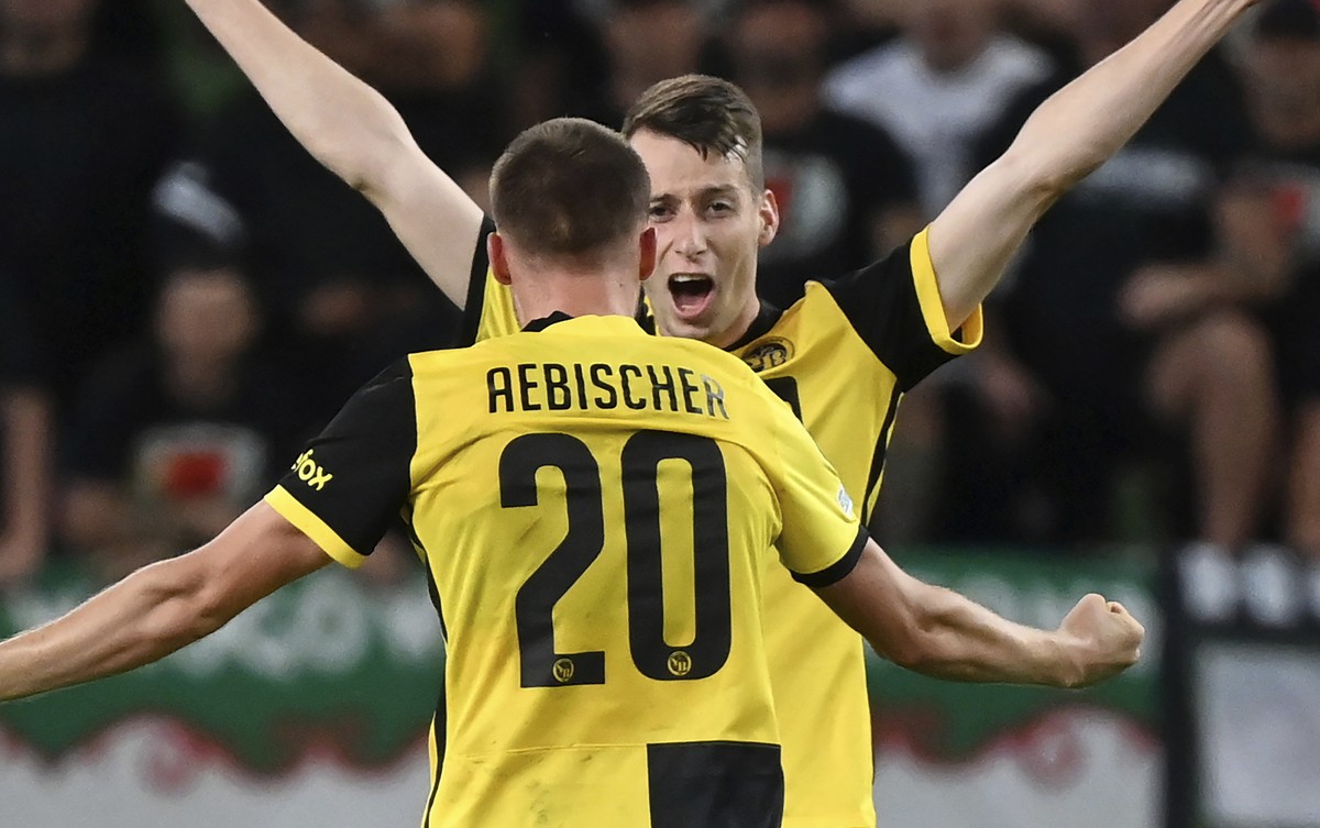 Young Boys' Sandro Lauper, right, and Michel Aebischer celebrate their victory after the Champions League Play-off second leg soccer match between Ferencvaros TC and BSC Young Boys of Switzerland ...