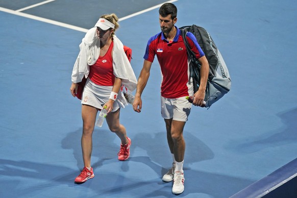 The Serbian mixed doubles team of Novak Djokovic, right, and Nina Stojanovic leave the court after being defeated by a team from the Russian Olympic Committee during the semifinals of the tennis compe ...