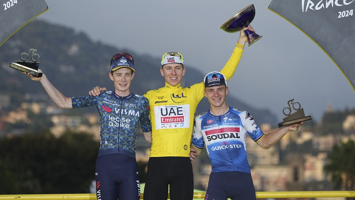 Tour de France winner Slovenia's Tadej Pogacar, wearing the overall leader's yellow jersey, Denmark's Jonas Vingegaard, left, and second place, and Belgium's Remco Evenepoel, right ...