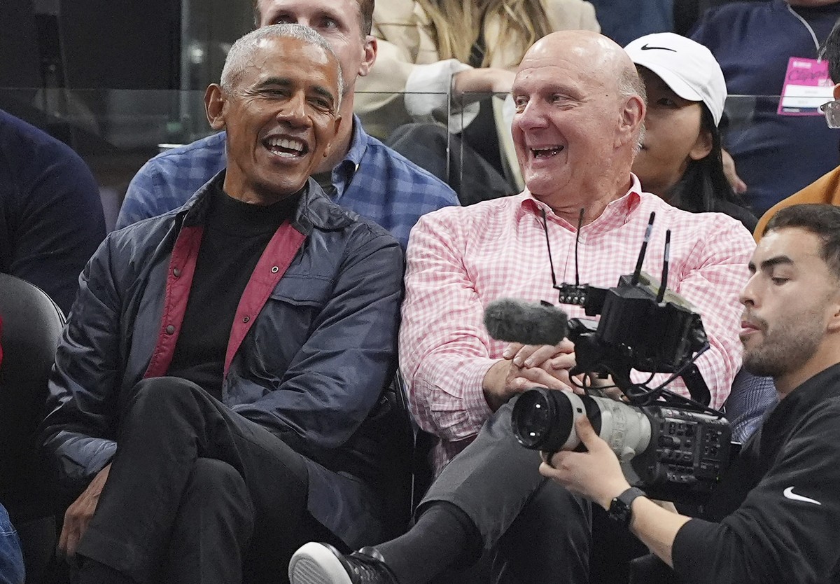 Former President Barack Obama, left, sits with Los Angeles Clippers owner Steve Ballmer during the first half of an NBA basketball game between the Clippers and the Detroit Pistons, Wednesday, March 5 ...