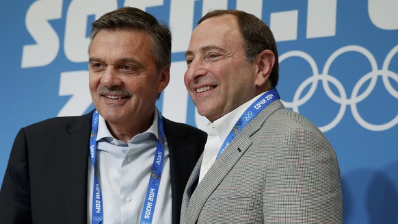 International Ice Hockey Federation (IIHF) President Rene Fasel poses for a picture with National Hockey League (NHL) Commissioner Gary Bettman (R) after a joint news conference at the 2014 Sochi Wint ...