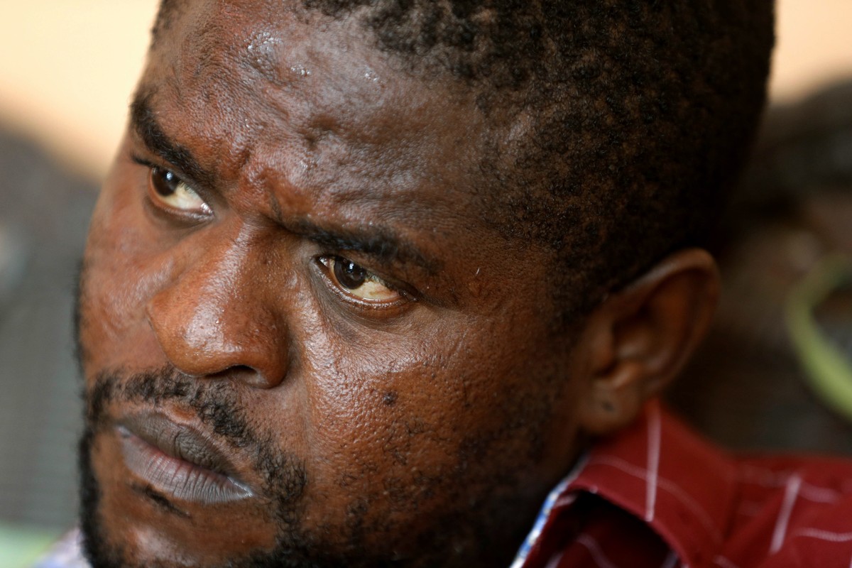 FILE - In this May 24, 2019 file photo, Barbecue, whose real name is Jimmy Cherizier, sits at his house during an interview with AP, in Lower Delmas, a district of Port-au-Prince, Haiti. He's a f ...