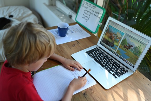 epa08333442 Six-year-old Oscar studies from home in Sydney, Australia, 31 March 2020. Many families have resorted to homeschooling and on-line learning as students were asked to stay home in an attemp ...