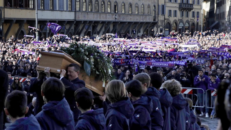The coffin is carried into the church during the funeral ceremony of Italian player Davide Astori in Florence, Italy, Thursday, March 8, 2018. The 31-year-old Astori was found dead in his hotel room o ...