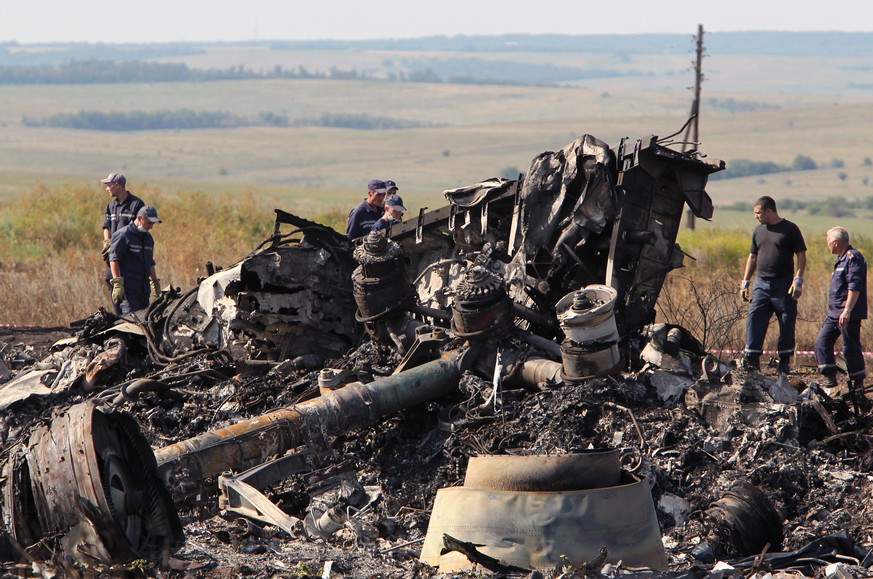 epa06762372 (FILE) - Ukrainian workers inspect debris at the main crash site of the Boeing 777 Malaysia Airlines flight MH17, which crashed over the eastern Ukraine region, near Grabovo, some 100 km e ...