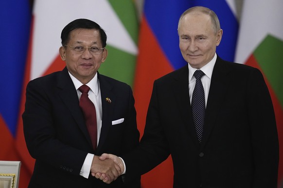 Russian President Vladimir Putin and Myanmar&#039;s Military leader Senior Gen. Min Aung Hlaing shake hands after a signing ceremony following their meeting at the Grand Kremlin Palace in Moscow, Russ ...
