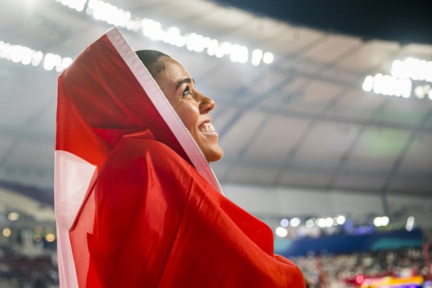 Bronze medal Mujinga Kambundji from Switzerland celebrates during the women&#039;s 200 meters final at the IAAF World Athletics Championships, at the Khalifa International Stadium, in Doha, Qatar, Wed ...