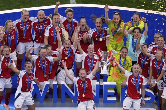 Arsenal&#039;s Kim Little, centre, holds the trophy as she celebrates with her teammates after winning the women&#039;s Champions League final soccer match between Arsenal and FC Barcelona at the Jose ...