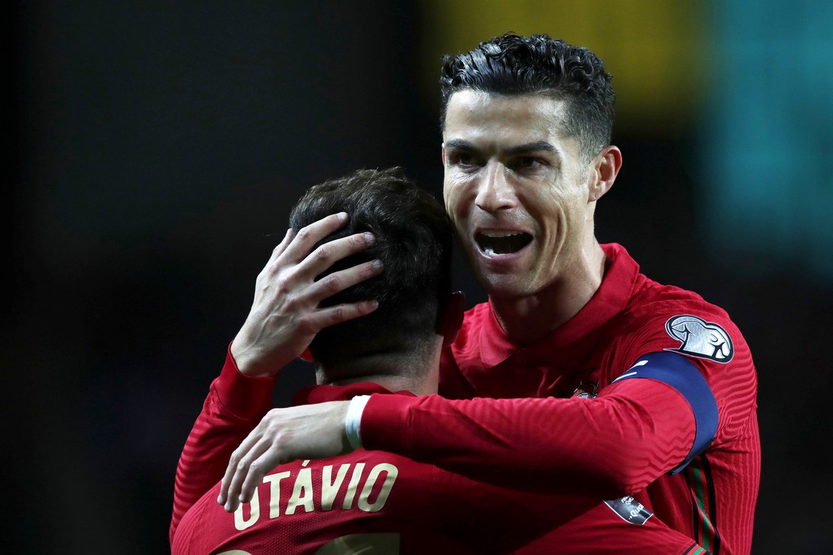 epa09847457 Portugal's Otavio (L) celebrates with his team mate Cristiano Ronaldo (R) after scoring during the FIFA World Cup Qatar 2022 play-off qualifying soccer match between Portugal and Turk ...