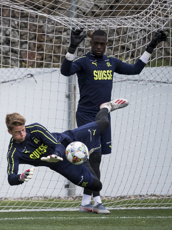 Switzerland&#039;s goalkeeper Jonas Omlin, left, and Switzerland&#039;s goalkeeper Yvon Mvogo, right, in action during a training session of the UEFA Nations League at the PortoGaia training center, i ...