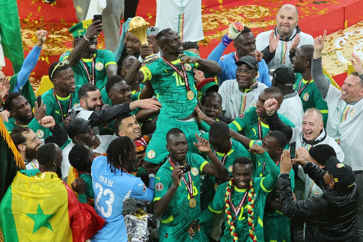 Senegal's Sadio Mane holds the trophy aloft as he celebrates with teammates after winning the Africa Cup of Nations final soccer match between Senegal and Morocco in Rabat, Morocco, Sunday, Jan.  ...