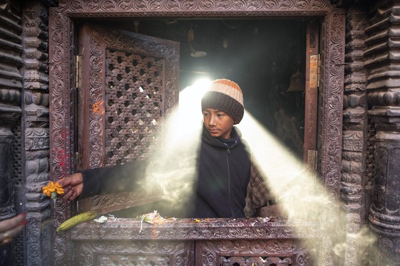 epaselect epa10933748 A child gives flowers to Hindu devotees at the Mahalaxmi temple of Bode on the ninth day of Dashain festival in Bhaktapur, Nepal, 23 October 2023. During the 15-day-long Dashain  ...