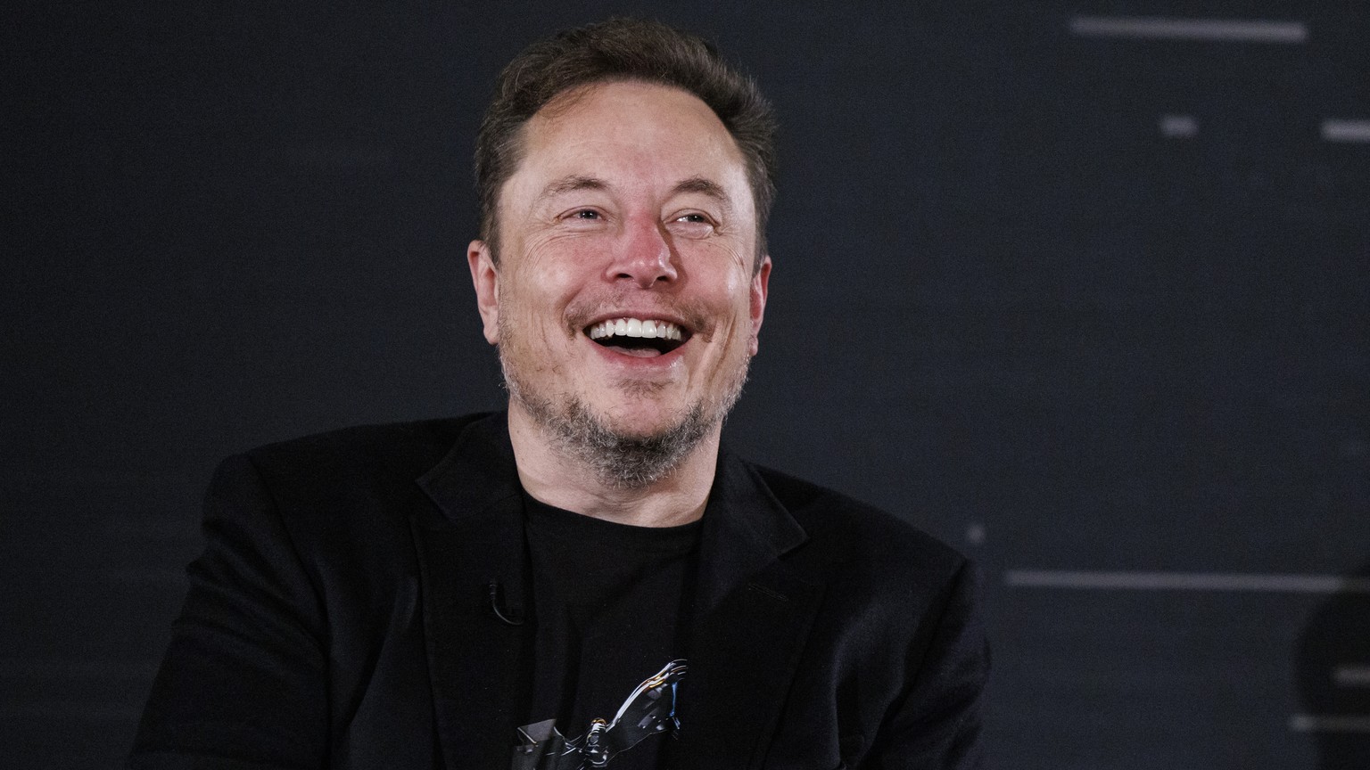 epa10955406 US tech entrepreneur Elon Musk, owner of Tesla, SpaceX and X, reacts as he attends a conversation event with British Prime Minister Rishi Sunak (unseen) in central London, Britain, 02 Nove ...