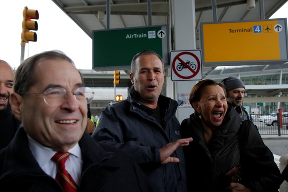 Iraqi immigrant Hameed Darwish (C) walks out of Terminal 4 with Congressman Jerrold Nadler (L) and Congresswoman Nydia Velazquez (R) after being released at John F. Kennedy International Airport in Qu ...