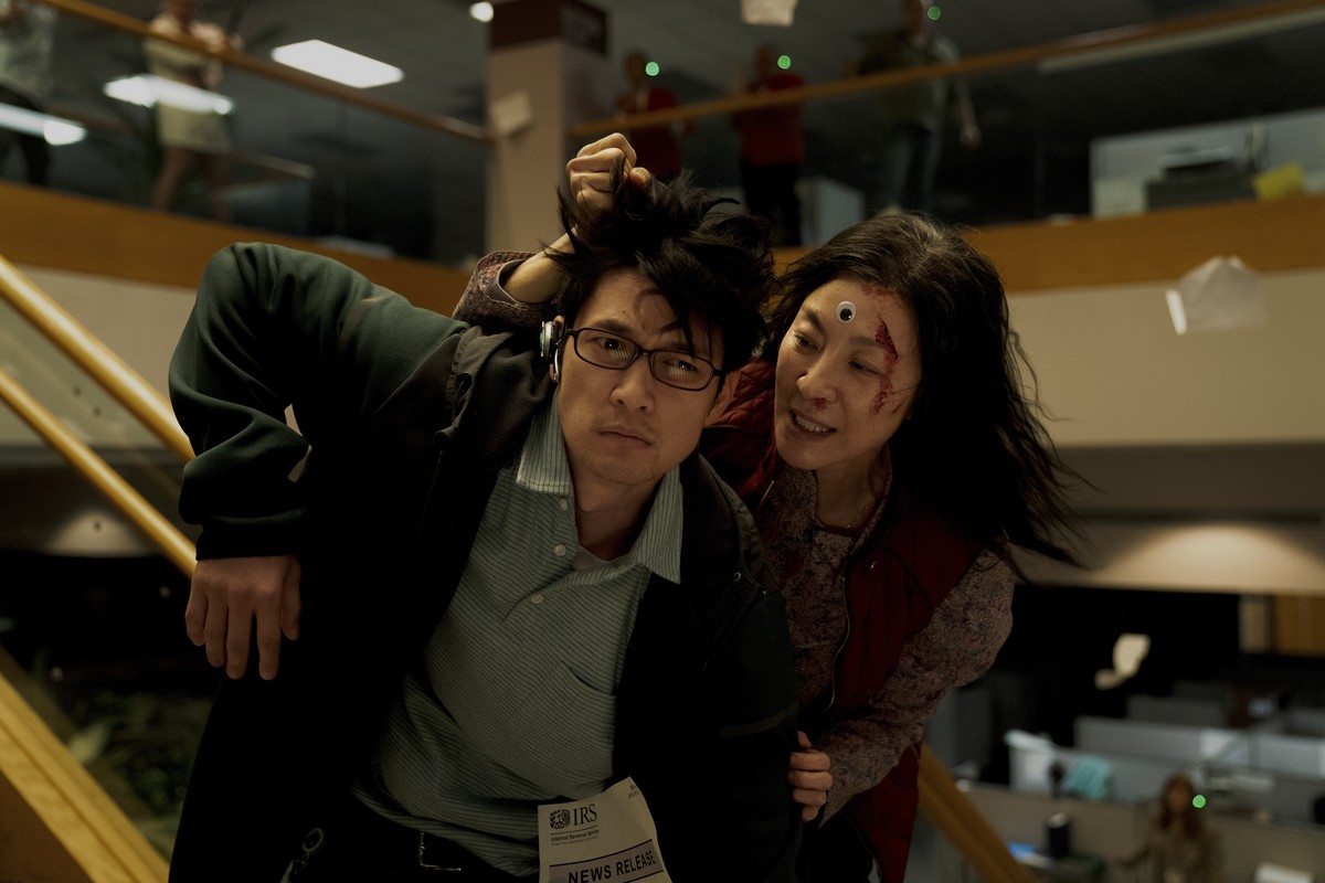 This image released by A24 shows Harry Shum Jr., left, and Michelle Yeoh in a scene from "Everything Everywhere All At Once." (Allyson Riggs/A24 via AP)