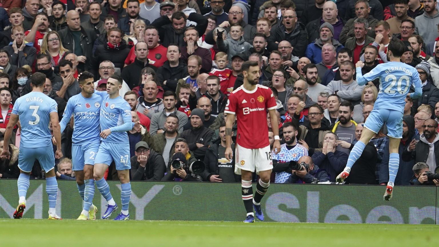 Manchester City players celebrates after Manchester United&#039;s Eric Bailly scored an own goal during the English Premier League soccer match between Manchester United and Manchester City at Old Tra ...