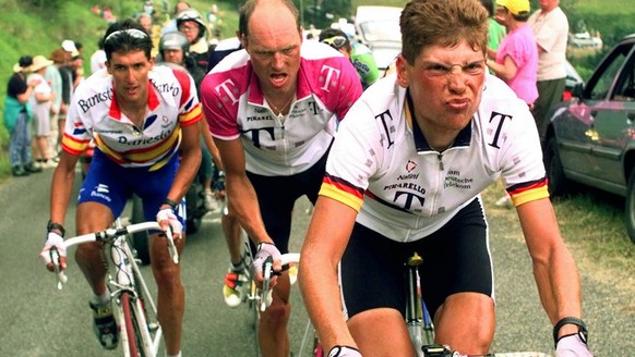 Jan Ullrich of Germany, right, grimaces as he climbs the Val de Louron-Azet pass ahead of his teammate Bjarne Riis of Denmark, center, and Jose-Maria Jimenez of Spain during the 9th stage of the Tour  ...