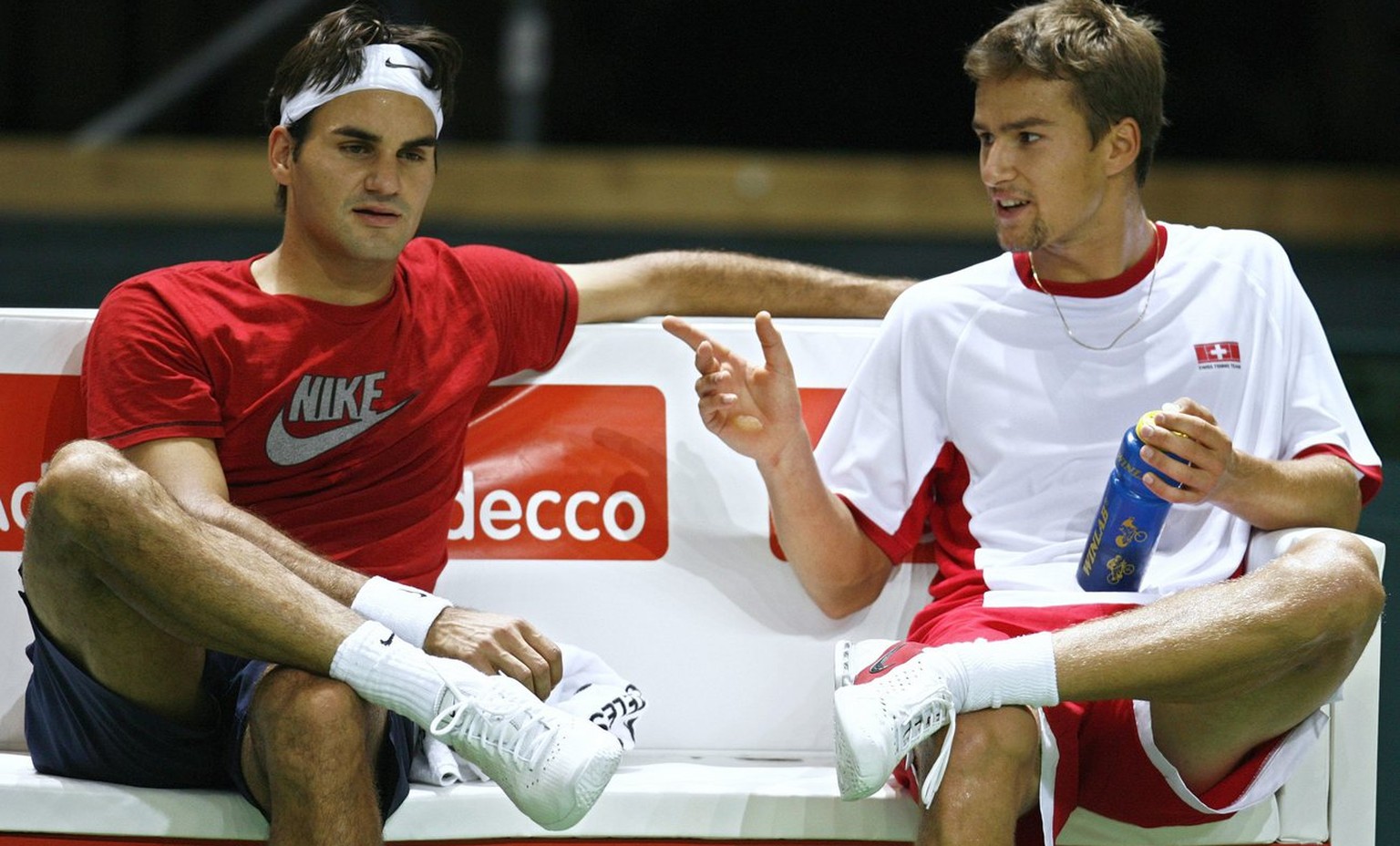World number one tennis player Roger Federer of Switzerland, left, and teammate Marco Chiudinelli, right, speak together during the first training session before their Davis Cup World Group Play-offs  ...