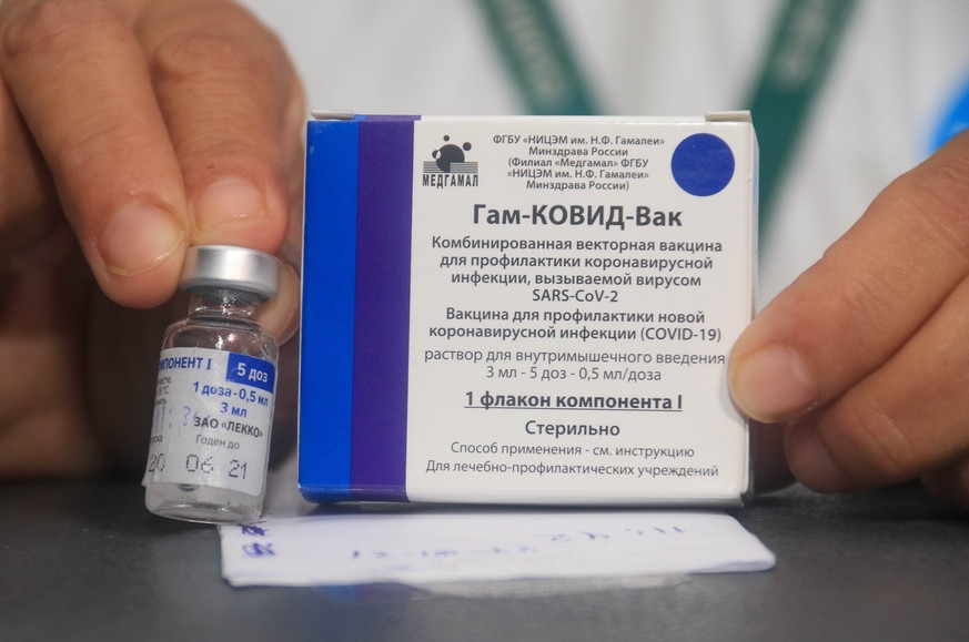 epa08981472 (FILE) - A nurse shows the vaccine against Covid-19 to apply it to doctors and health workers, after the arrival of the first 20,000 doses of the Russian Sputnik V, at the Japanese Hospita ...