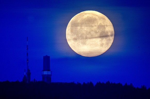 The moon can be seen above the summit of Feldberg near Frankfurt, Germany, early Saturday, May 6, 2023. (AP Photo/Michael Probst)