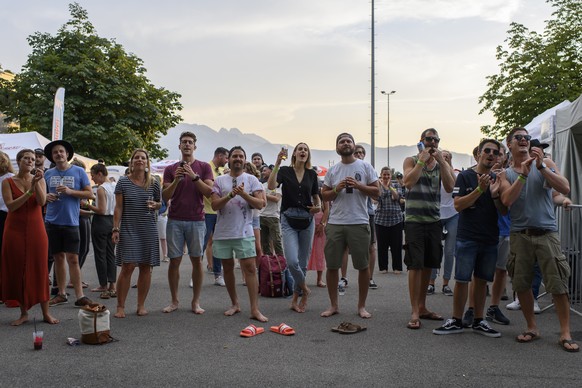 Festival goers enjoy the concert of the Swiss band ?Hot Like Sushi?, at the ?Swiss Mountain Roadshow?, during the coronavirus disease (COVID-19) outbreak, in Steffisburg, Switzerland, Thursday, July 3 ...