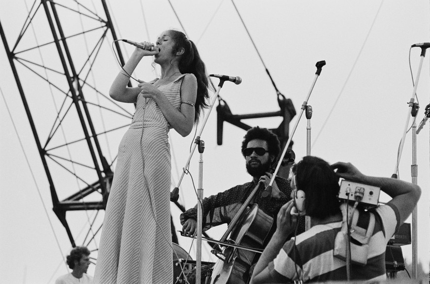 A cameraman (bottom, right) films singer Nancy Nevins and cellist August Burns as they perform with American rock band Sweetwater at the Woodstock Music Festival, Bethel, New York, 15th August 1969. ( ...