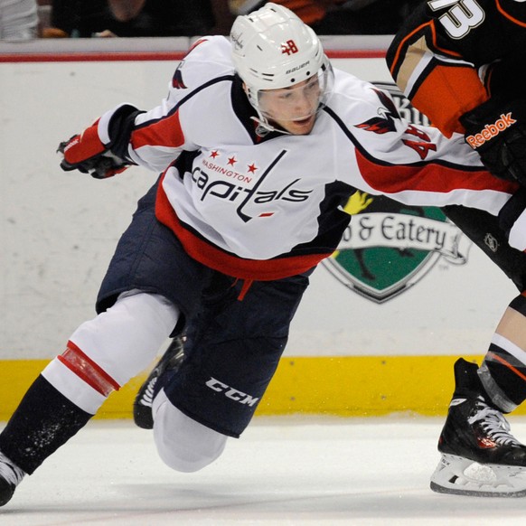 Mar 18, 2014; Anaheim, CA, USA; Anaheim Ducks center Nick Bonino (13) attempts to move the puck defended by Washington Capitals center Casey Wellman (48) during the second period at Honda Center. Mand ...