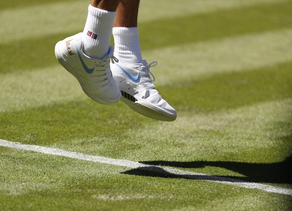 epa06857860 Roger Federer of Switzerland serves to Dusan Lajovic of Serbia in their first round match during the Wimbledon Championships at the All England Lawn Tennis Club, in London, Britain, 02 Jul ...