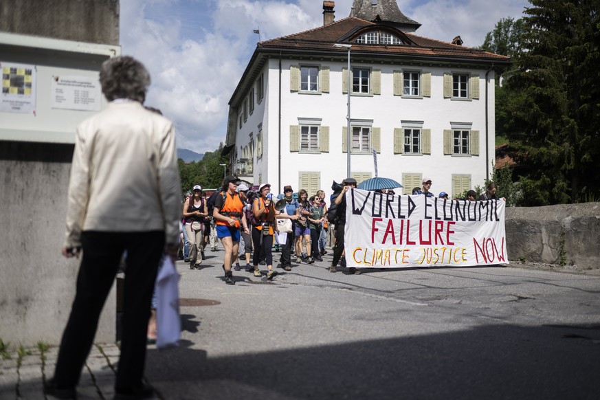 epa09962234 Protesters of the organization &#039;Strike WEF&#039; gather for a march to Davos, prior to the annual meeting of the World Economic Forum (WEF), in Kueblis, Switzerland, 21 May 2022. The  ...