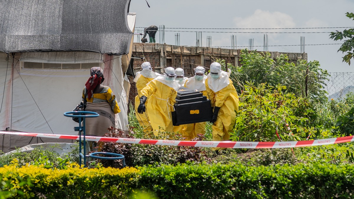 Red Cross workers carry the coffin of a person who died of Ebola at a health center in Rwampara, Congo, Wednesday, May 20, 2026. (AP Photo/Moses Sawasawa)