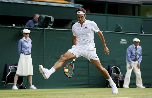 Roger Federer of Switzerland hits a shot through his legs during his match against Sam Querrey of the U.S.A. at the Wimbledon Tennis Championships in London, July 2, 2015. REUTERS/Stefan Wermuth