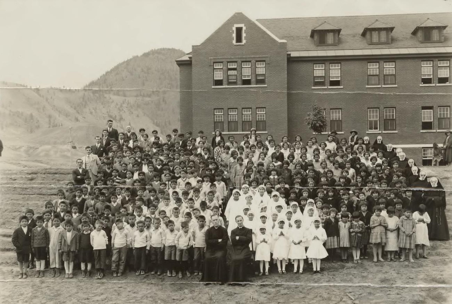 epa09236277 A handout photo made available by the National Centre for Truth and Reconciliation at the University of Manitoba reportedly shows a gathering at the Kamloops Indian Residential School in K ...