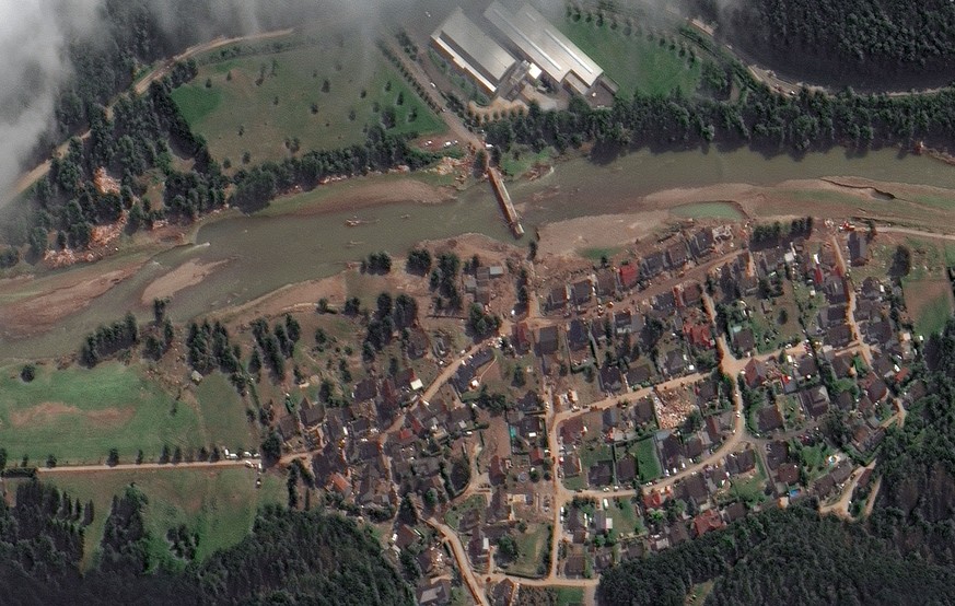 This satellite image provided by Maxar Technologies shows a destroyed bridge and mud covered streets near the flooded Ahr River in Liers, Germany, Sunday, July 18, 2021. (Steve Wood/Satellite image ©2 ...