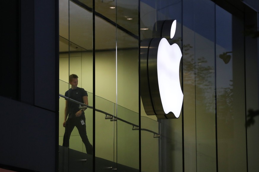 epa06305382 An Apple employee walks near an Apple logo during the sale start of the new iPhone X at the Apple store Grosse Bockenheimer Strasse in Frankfurt, Germany, 03 October 2017. Apple&#039;s new ...