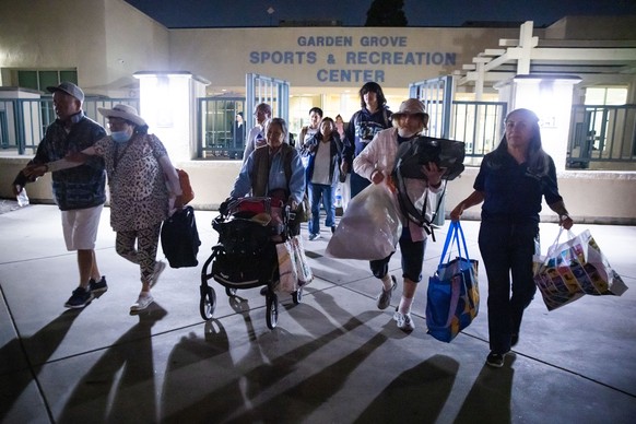 Evacuees from an aerospace chemical plant tank leak move to another shelter after the Garden Grove Sports and Recreation Center closed for the night in Garden Grove, Calif., Friday, May 22, 2026. (AP  ...