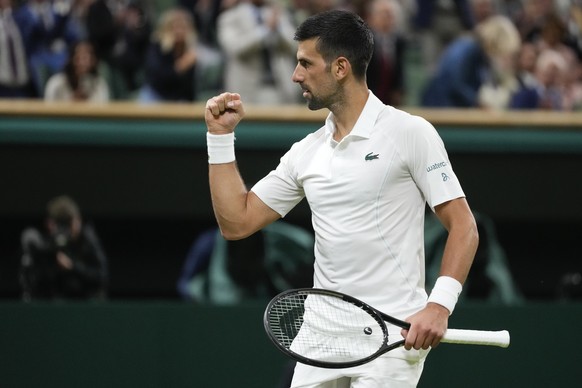 Novak Djokovic of Serbia celebrates after defeating Holger Rune of Denmark in their fourth round match at the Wimbledon tennis championships in London, Monday, July 8, 2024. (AP Photo/Kirsty Wiggleswo ...