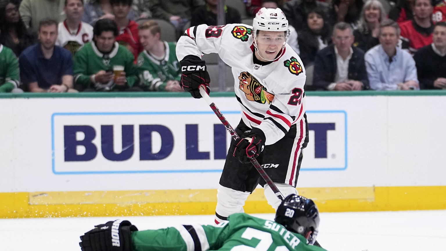 Chicago Blackhawks center Philipp Kurashev (23) makes a pass as Dallas Stars&#039; Ryan Suter (20) attempts to block in the second period of an NHL hockey game, Wednesday, Feb. 22, 2023, in Dallas. Pa ...