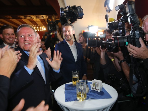 epa05546403 Georg Pazderski (L), State Chairman and Lead Candidate for Alternative for Germany (AfD) is surronded by the press at the election party for the vote of the Berlin House of Representatives ...